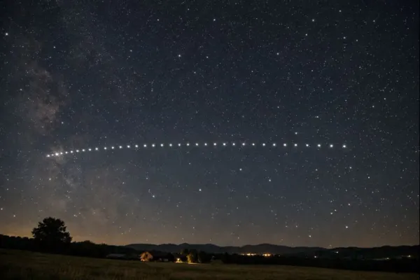 Starlink satellites appearing in a straight line as they move across the night sky.