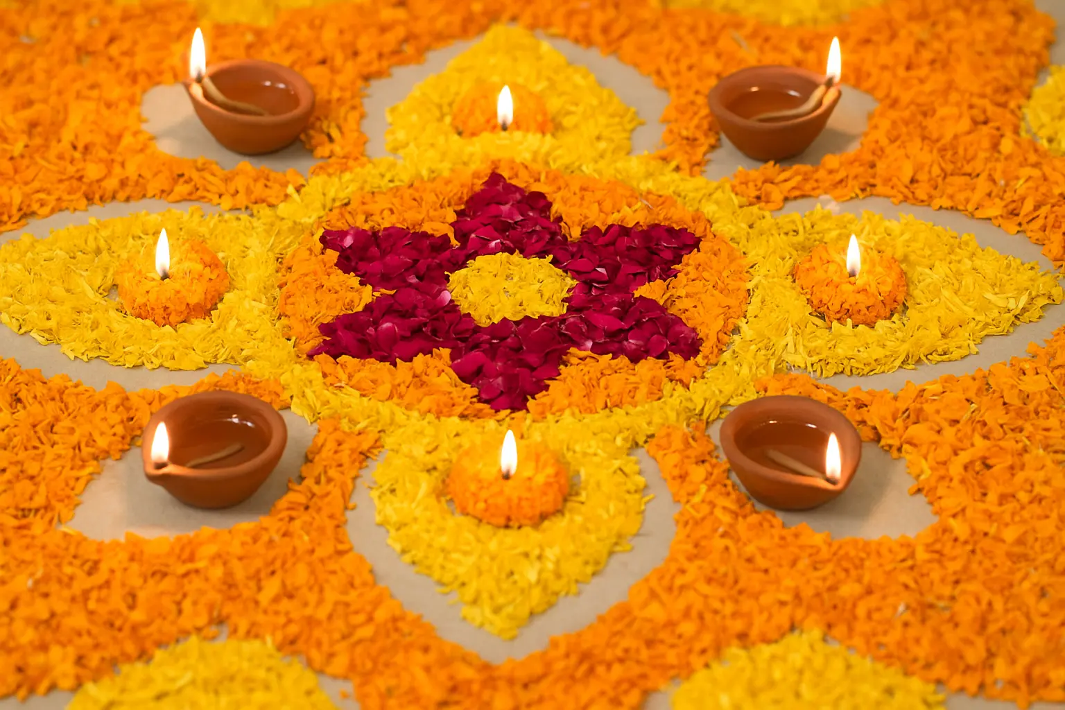Traditional Diwali rangoli with flowers and diyas.